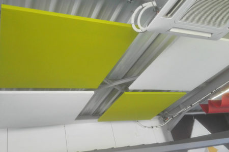 Panneaux acoustiques verts et blancs accrochés au plafond du Showroom Sofareb en Vendée